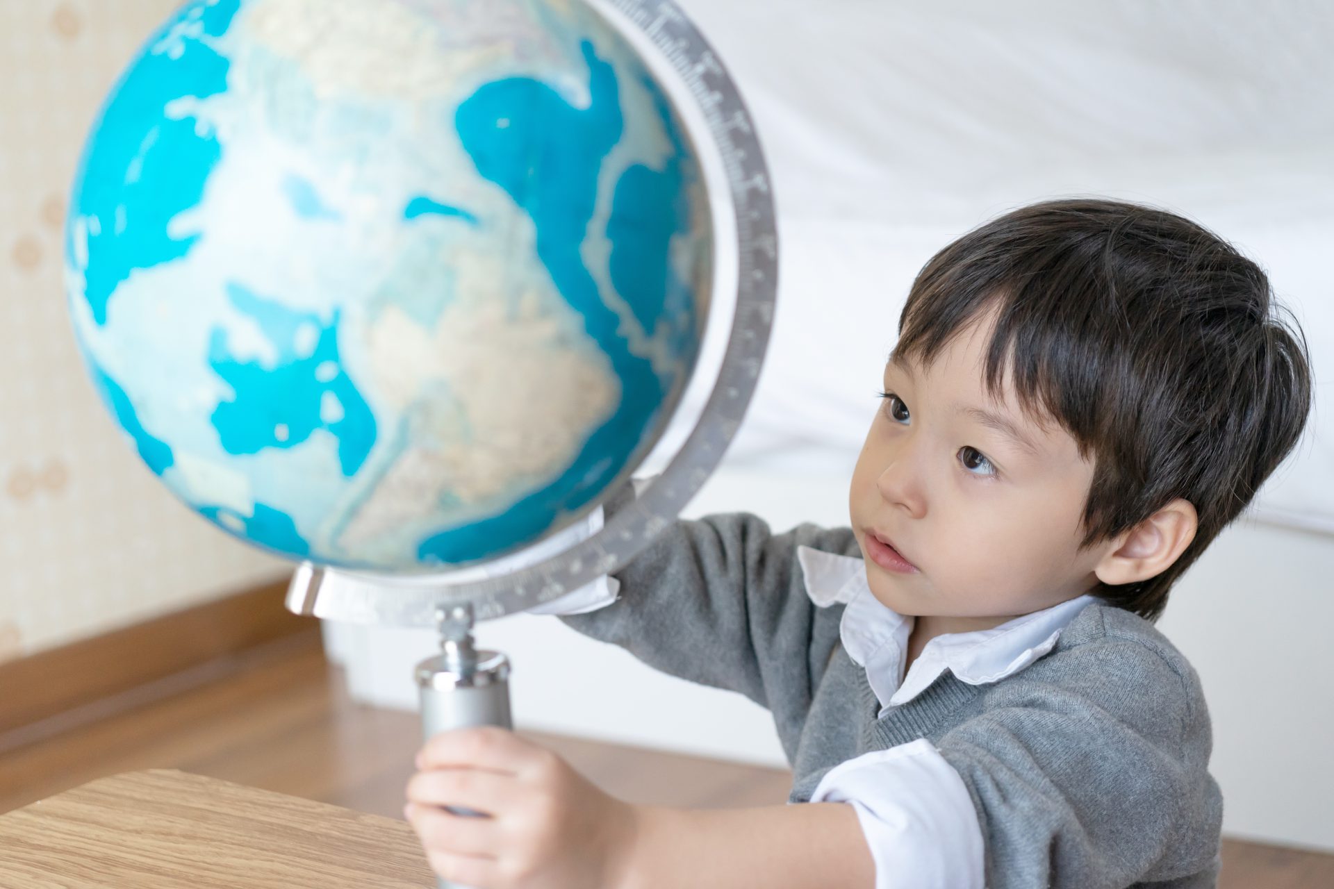 little boy playing with globe home